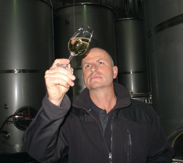 Daniel Schwarzenbach checks the 2011 vintage of their vegan wine